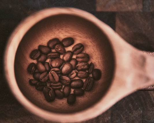 brown coffee beans in brown ceramic mug